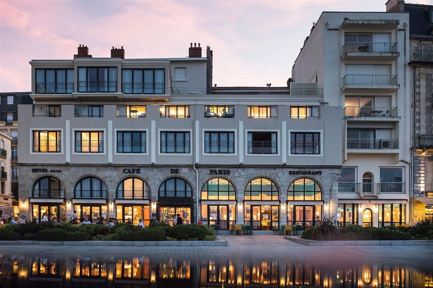 Cafe de Paris hotel and restaurant in Biarritz, a corporate dinner venue, with outdoor seating at dusk.