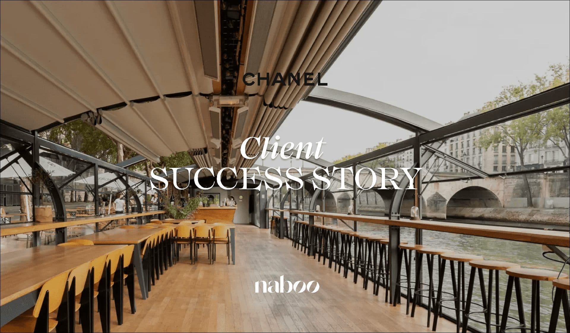 Modern event barge interior in Paris with tables, chairs, and bar stools, offering a waterfront view.