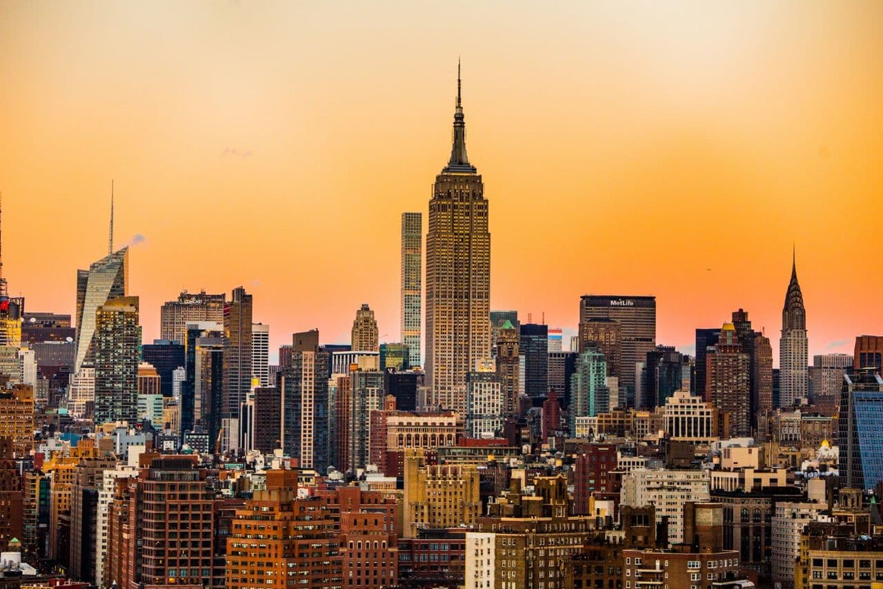 New York City skyline at sunset, featuring the Empire State Building and other iconic corporate event venues.