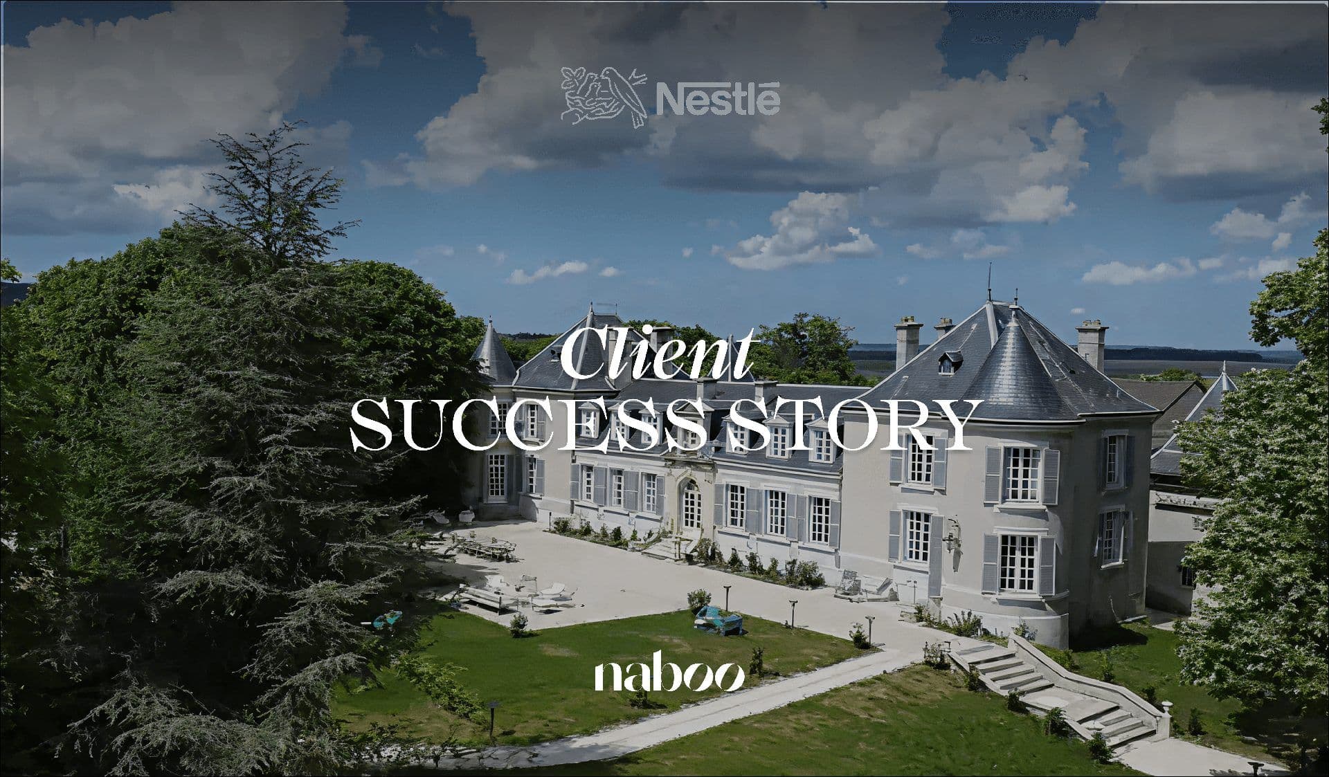 Aerial view of a grand French château, a historic venue with green lawns and a bay