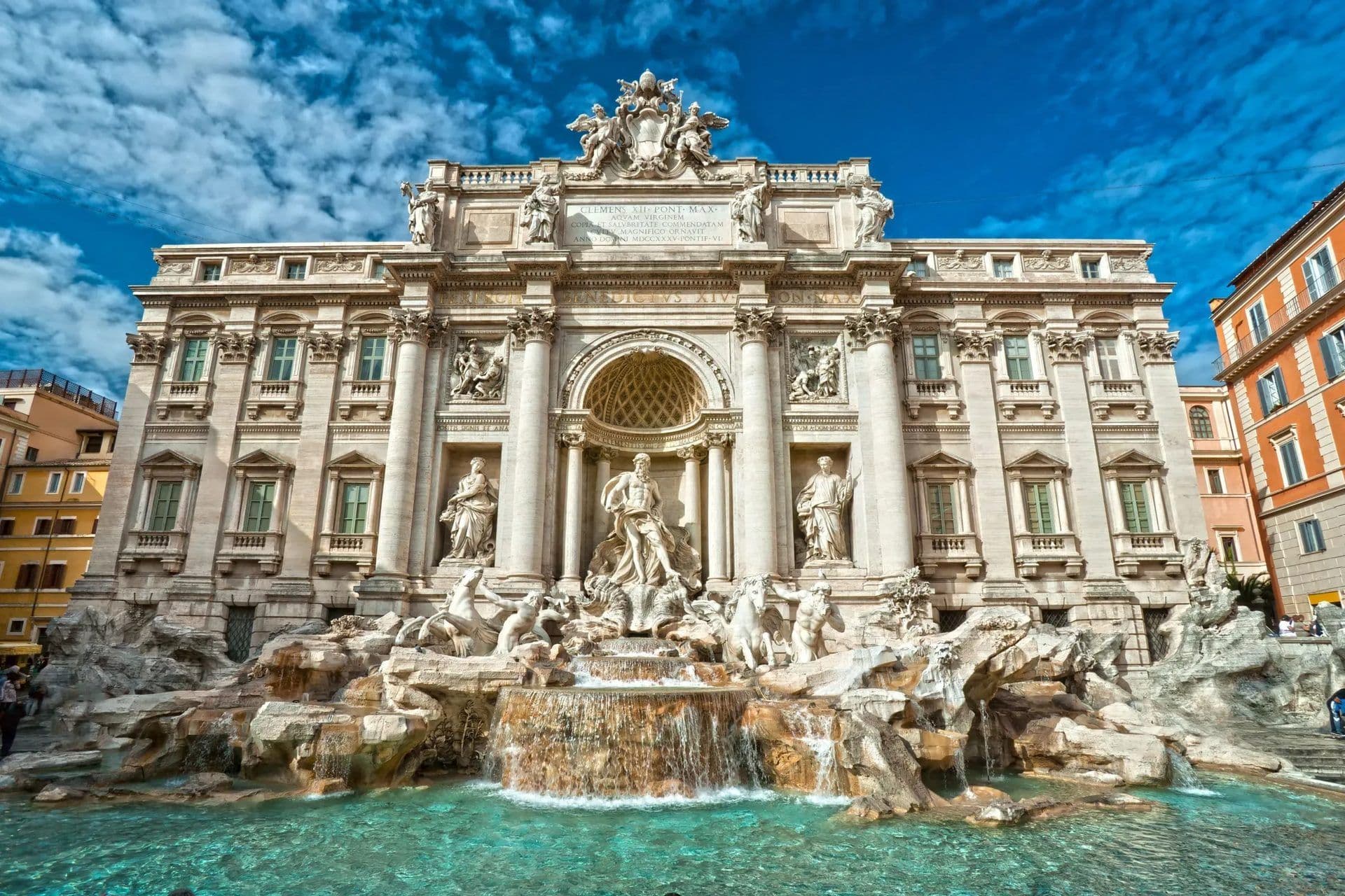 The iconic Trevi Fountain in Rome, Italy, featuring elaborate Baroque sculptures and turquoise water under a