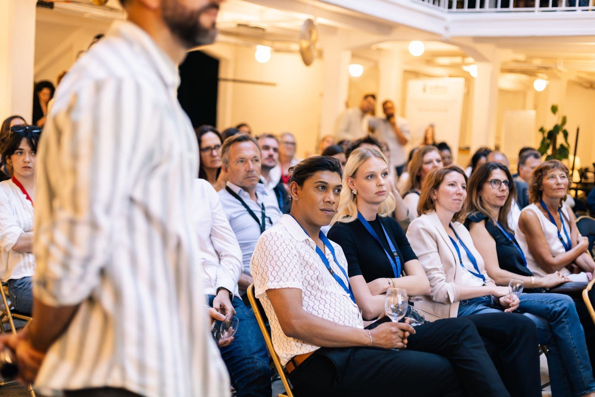 Diverse group of professionals attending a corporate seminar in a bright, contemporary conference space.