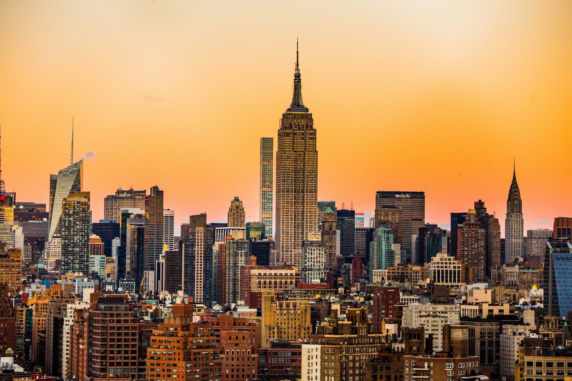 Panoramic view of the New York City skyline at golden hour, featuring iconic corporate event venues.