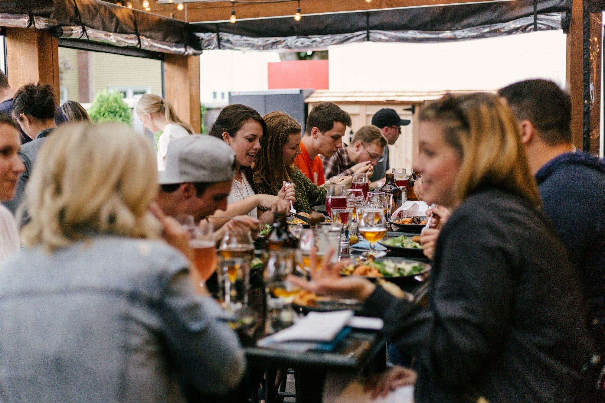 Colleagues sharing a meal and conversation at a corporate Thanksgiving dinner