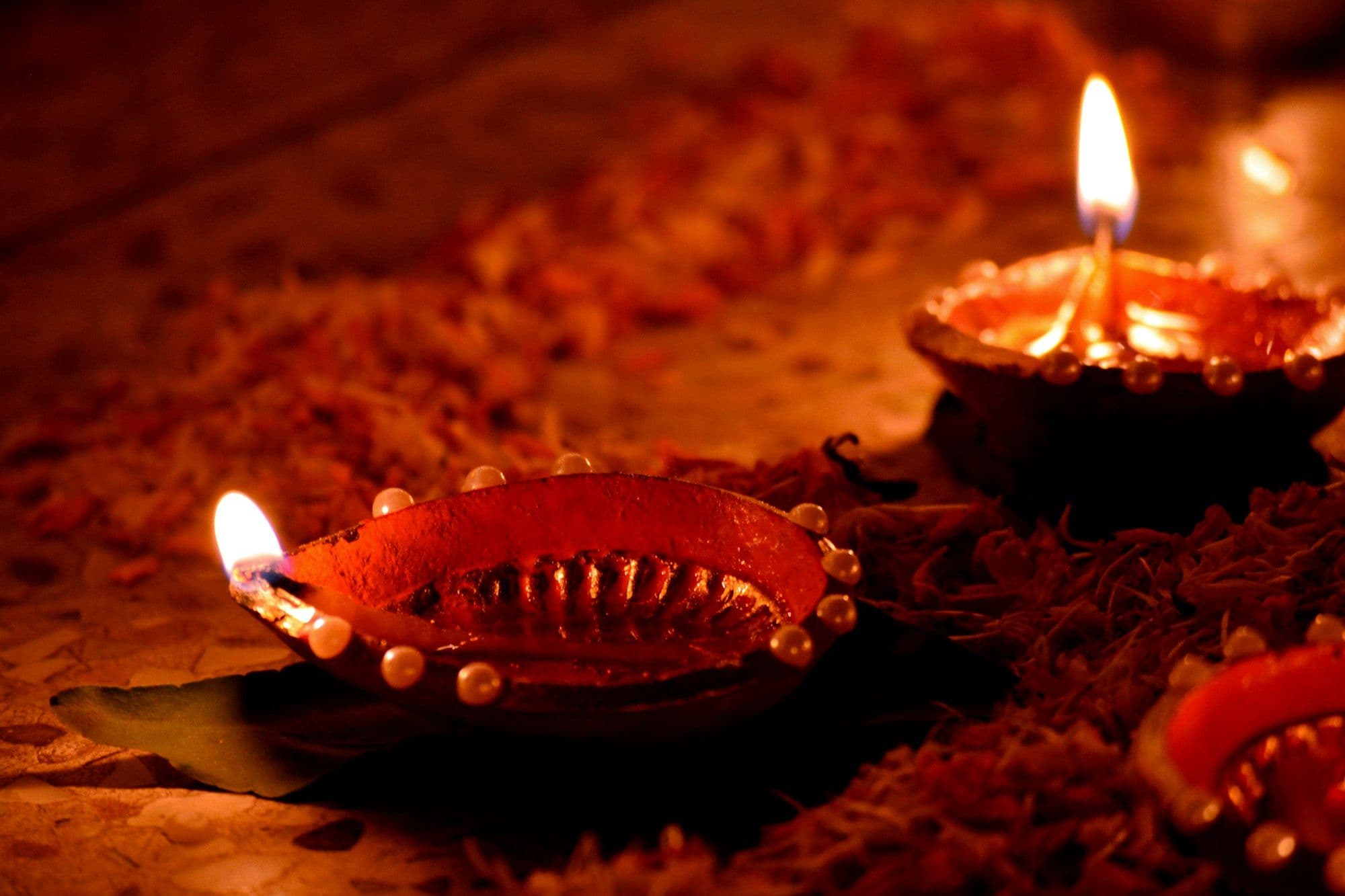 Warm candles arranged on a table for an office Diwali celebration
