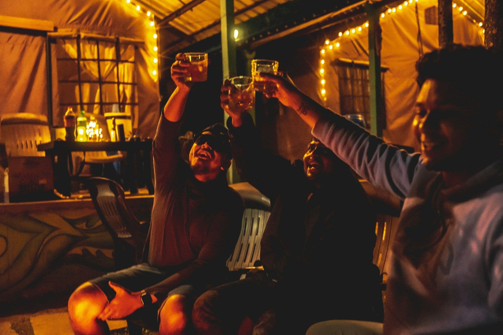 A group of coworkers raising glasses of beer together at an Oktoberfest party