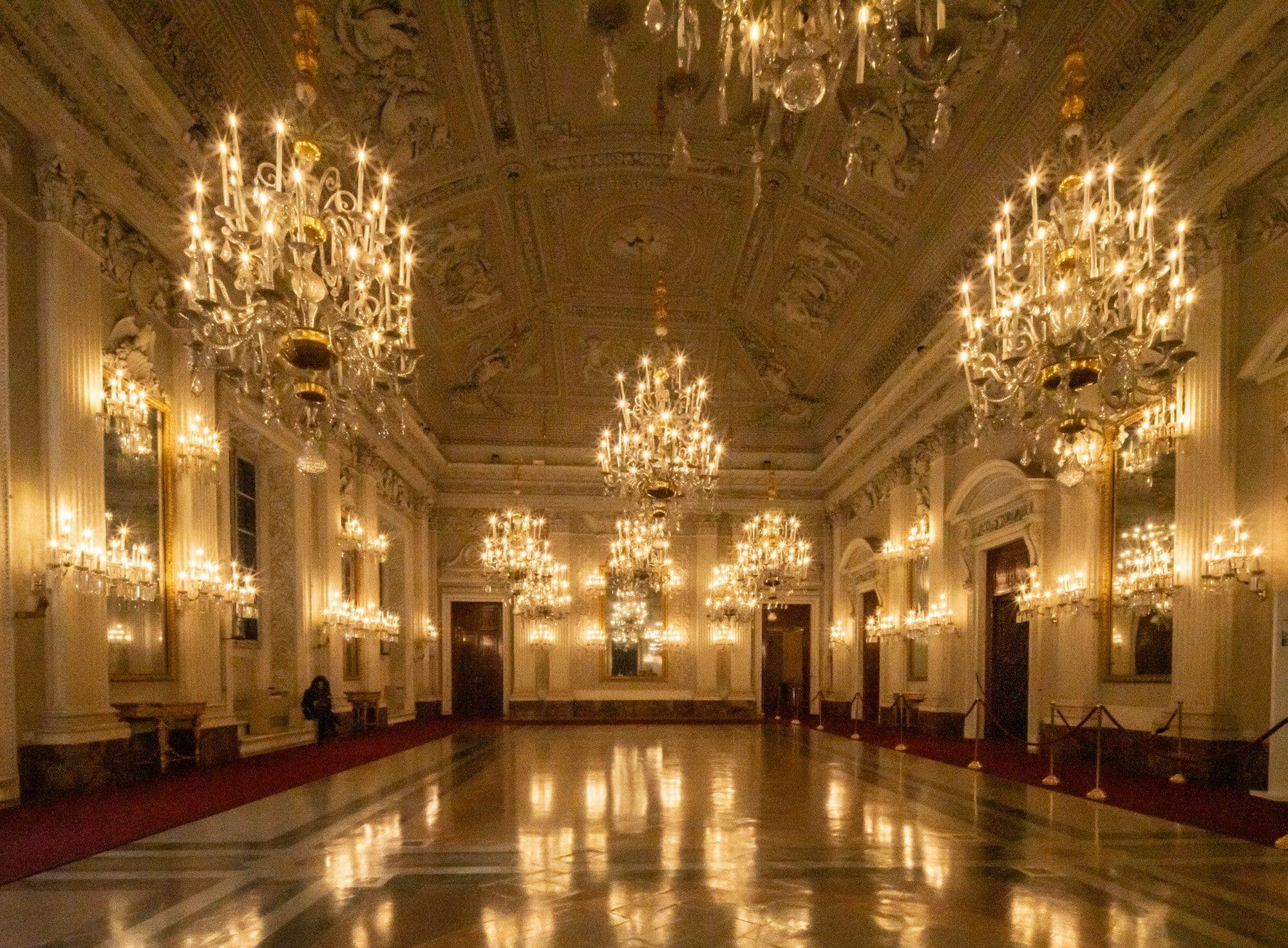 A grand ballroom with chandeliers set for a company New Year's Eve gala