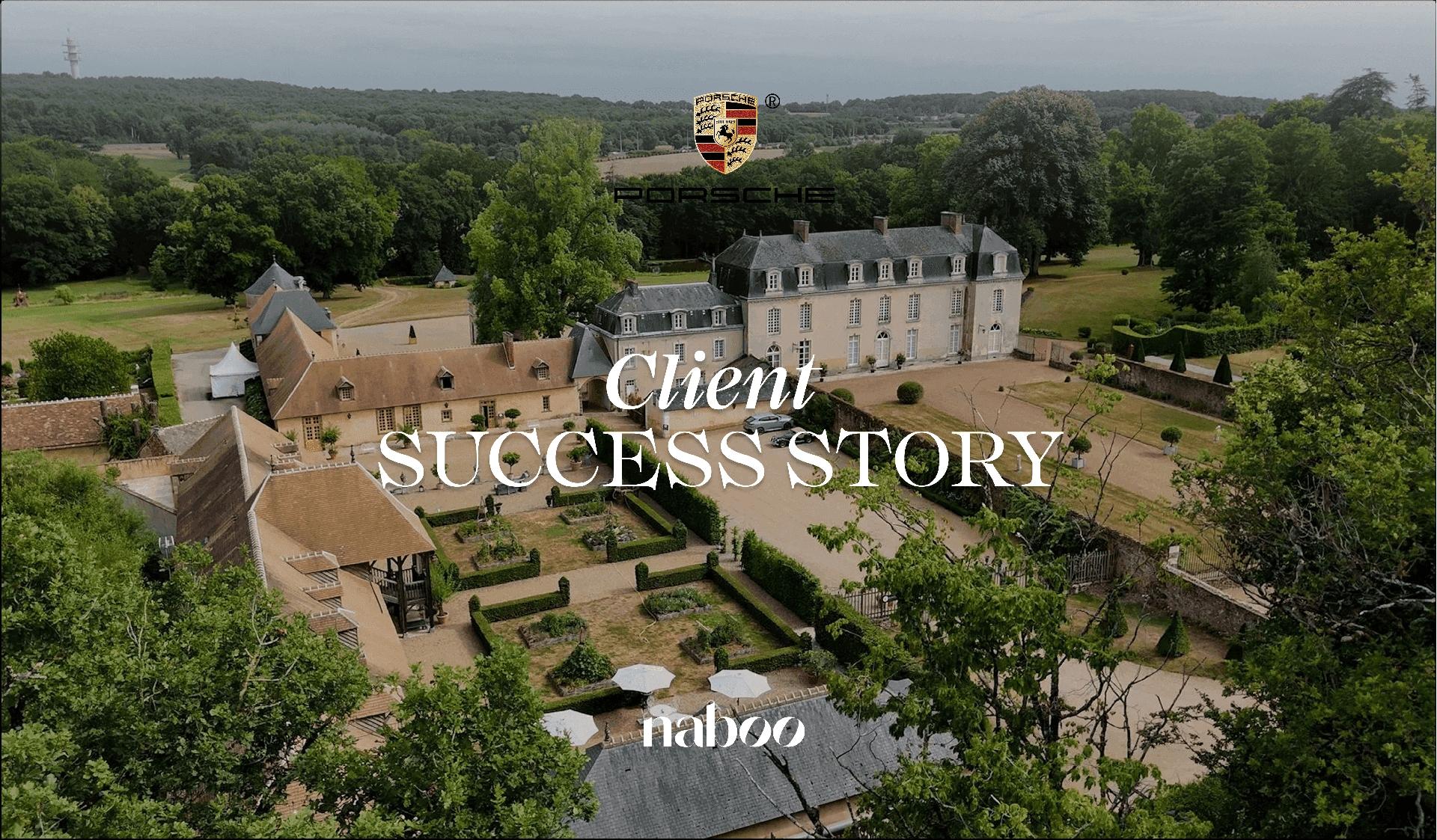 Aerial view of a historic French château estate with formal gardens, multiple buildings